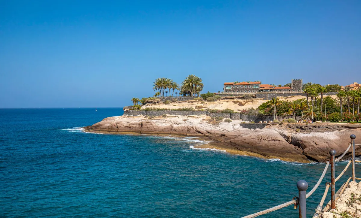 Costa Adeje coastline with the rocky Playa del Duque headland and clear blue water