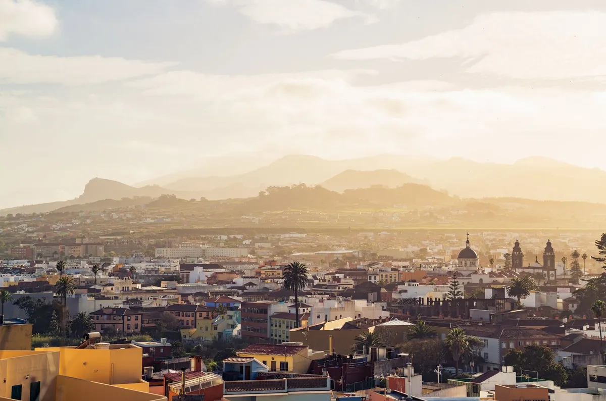 Rooftops and church towers of the historic town of La Laguna, with mountains behind, in northern Tenerife