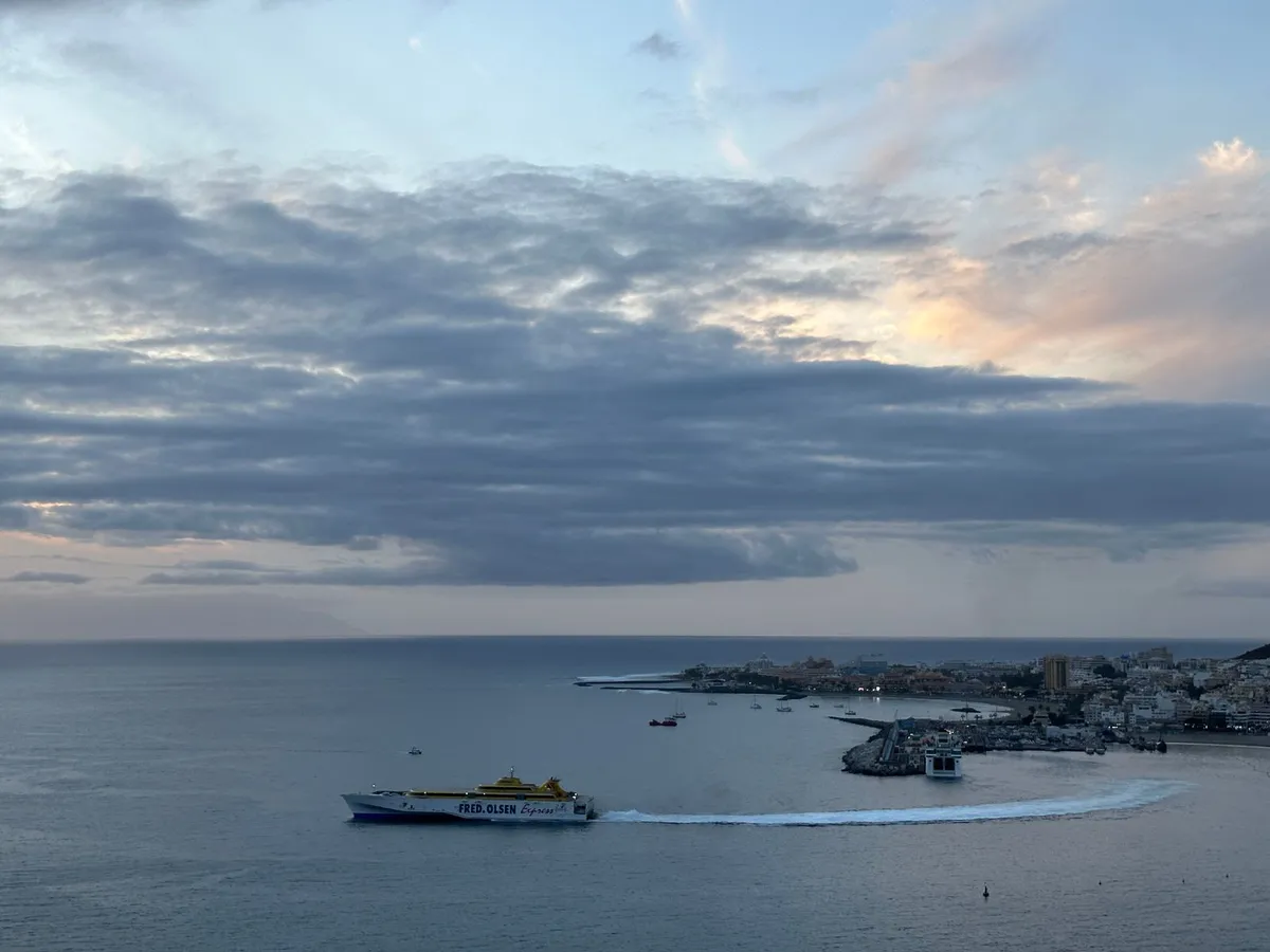 Los Cristianos harbour at dusk with a ferry departing, south Tenerife