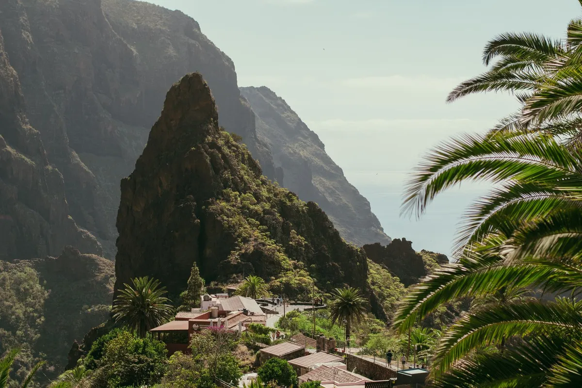 The village of Masca and its landmark rock pinnacle set among steep gorge cliffs, with the Atlantic beyond